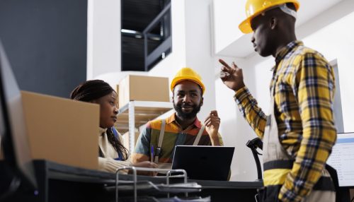 Logistics managers team dicussing goods distribution at warehouse reception